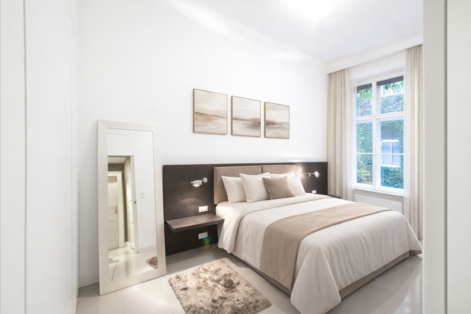 Principal bedroom with bridge prints and warm lamplight